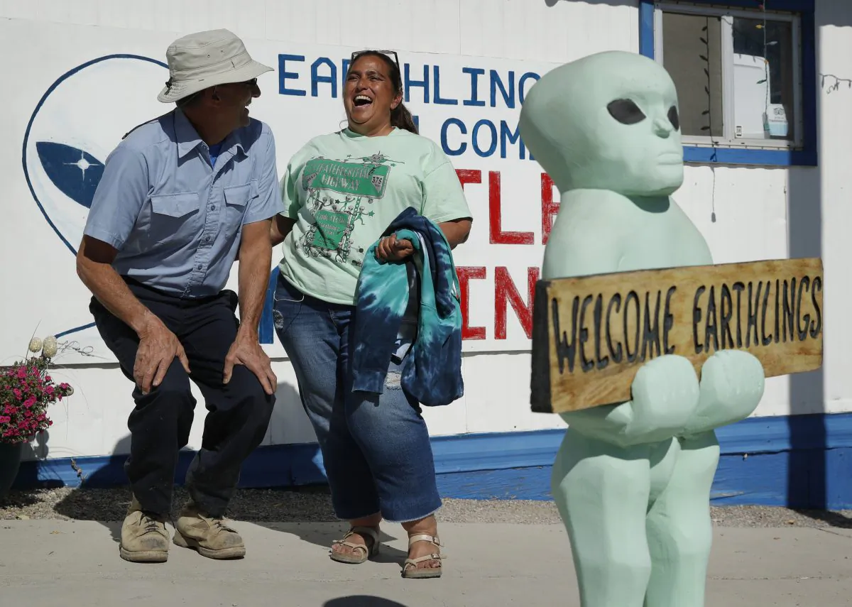 Little A'Le'Inn owner Connie West, right, laughs with Kirk Schultz outside the bar and restaurant, in Rachel, Nev., on Sept. 18, 2019. (AP Photo/John Locher)