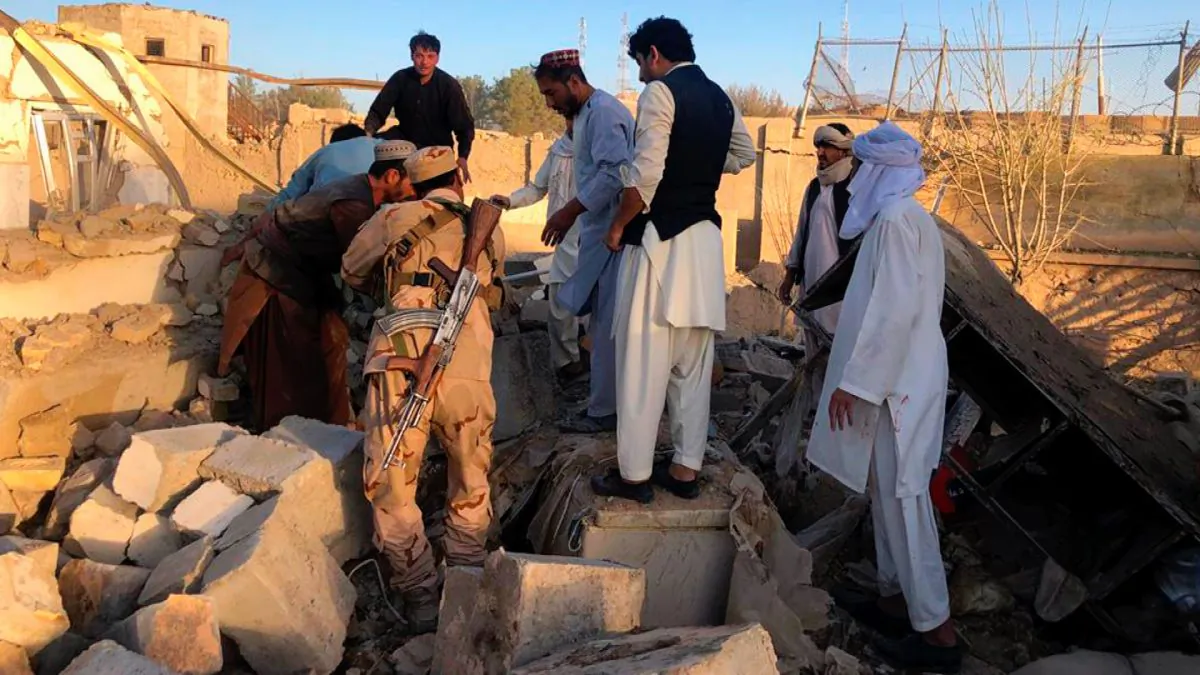 Afghan security members and people work at the site of a suicide attack in Zabul, Afghanistan, on Sept. 19, 2019. (Ahmad Wali Sarhadi/AP Photo)