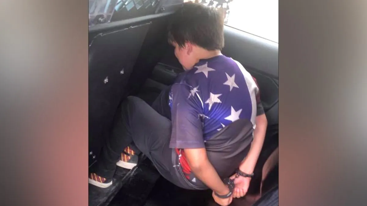 11-year-old Abraham Hibbert handcuffed. (Courtesy of Trevor Hibbert)