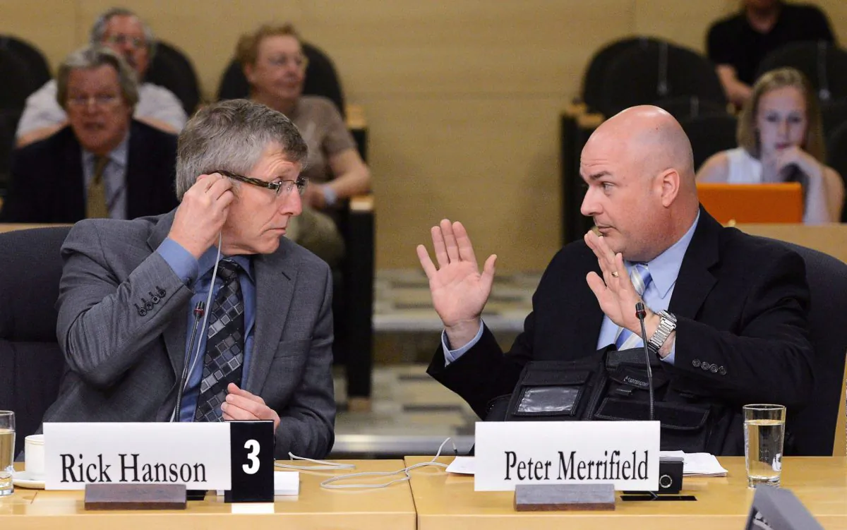 Rick Hanson, chief of the Calgary Police Service, and Peter Merrifield, president of the Mounted Police Association of Ontario, appear at Senate national security committee to discuss harassment in the RCMP on May 27, 2013. The Supreme Court of Canada will not hear Merrifield's argument that he should be compensated for alleged harassment by superiors. (THE CANADIAN PRESS/Sean Kilpatrick)