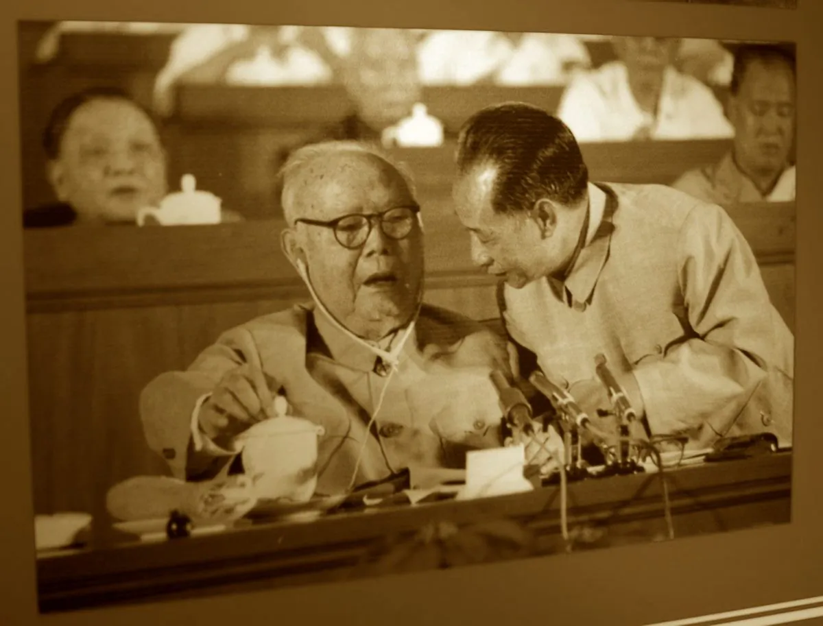 This photo taken on Nov. 2, 2012 shows the late disgraced Chinese leader Zhao Ziyang (R) talking to Ye Jianying, one of the founders of the Communist Party of China, with Hu Yaobang (back R) who also fell from power, and late patriarch Deng Xiaoping (back L), taken during the 12th party congress in 1982, on display at the press center for the upcoming Chinese Communist Party 18th Congress in Beijing. (Stéphane Lagarde/AFP/Getty Images)