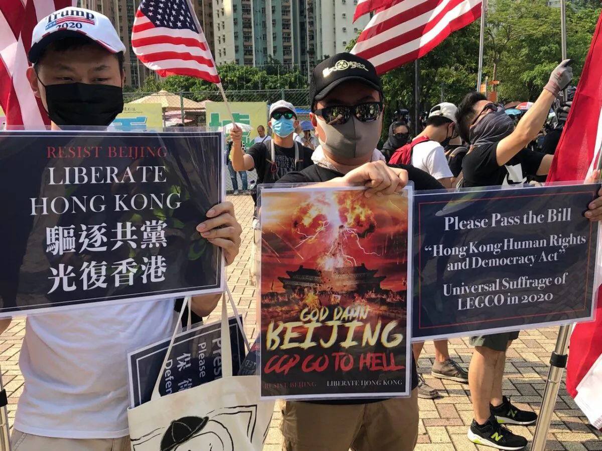 Protesters hold up anti-communist placards during a rally in Hong Kong on Sept. 14, 2019. (Yu Tianyou/The Epoch Times)
