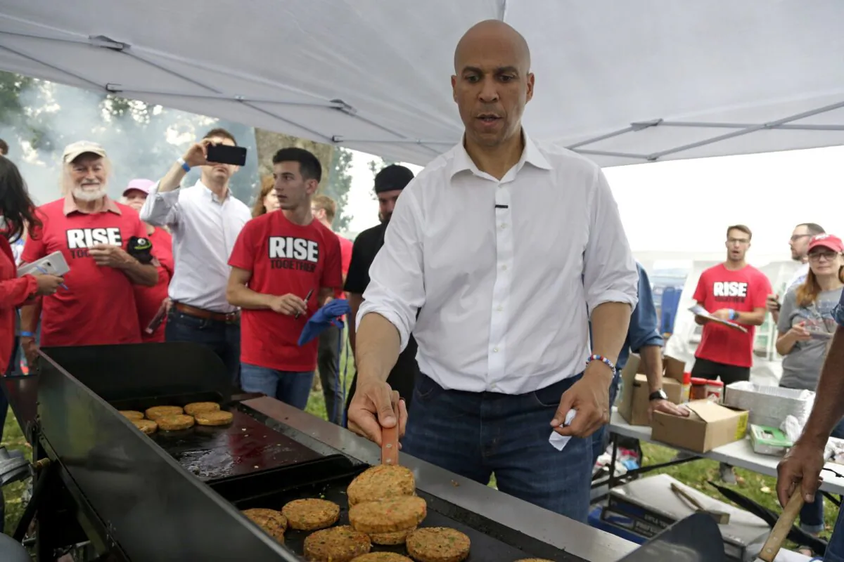 Democratic presidential candidate Sen. Cory Booker (D-N.J.) flips veggie burgers at the Polk County Democrats Steak Fry, in Des Moines, Iowa on Sept. 21, 2019. He's among the Democratic presidential candidates who support confiscating guns. (Nati Harnik/AP Photo)