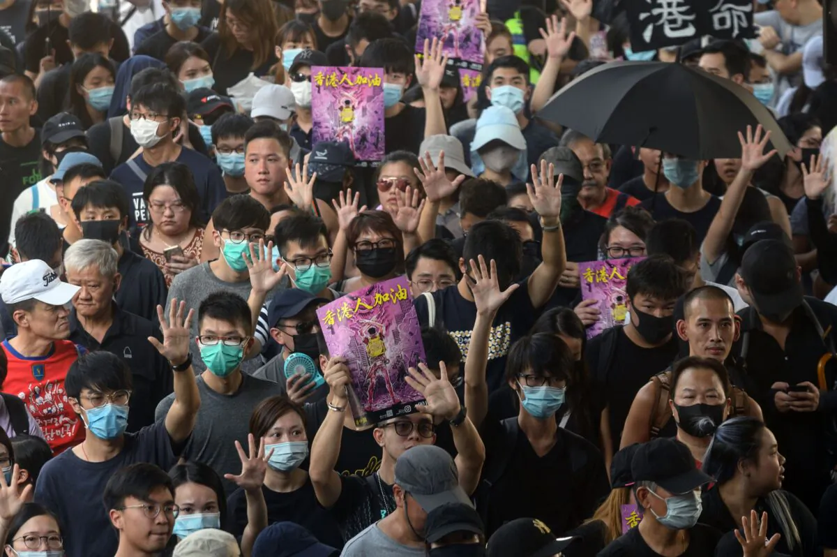 Demonstrators hold up their hands to symbolise the five demands that protesters are asking for, as they take part in a pro-democracy rally in Hong Kong's Tuen Mun district on Sept. 21, 2019. (Philip Fong/AFP/Getty Images)