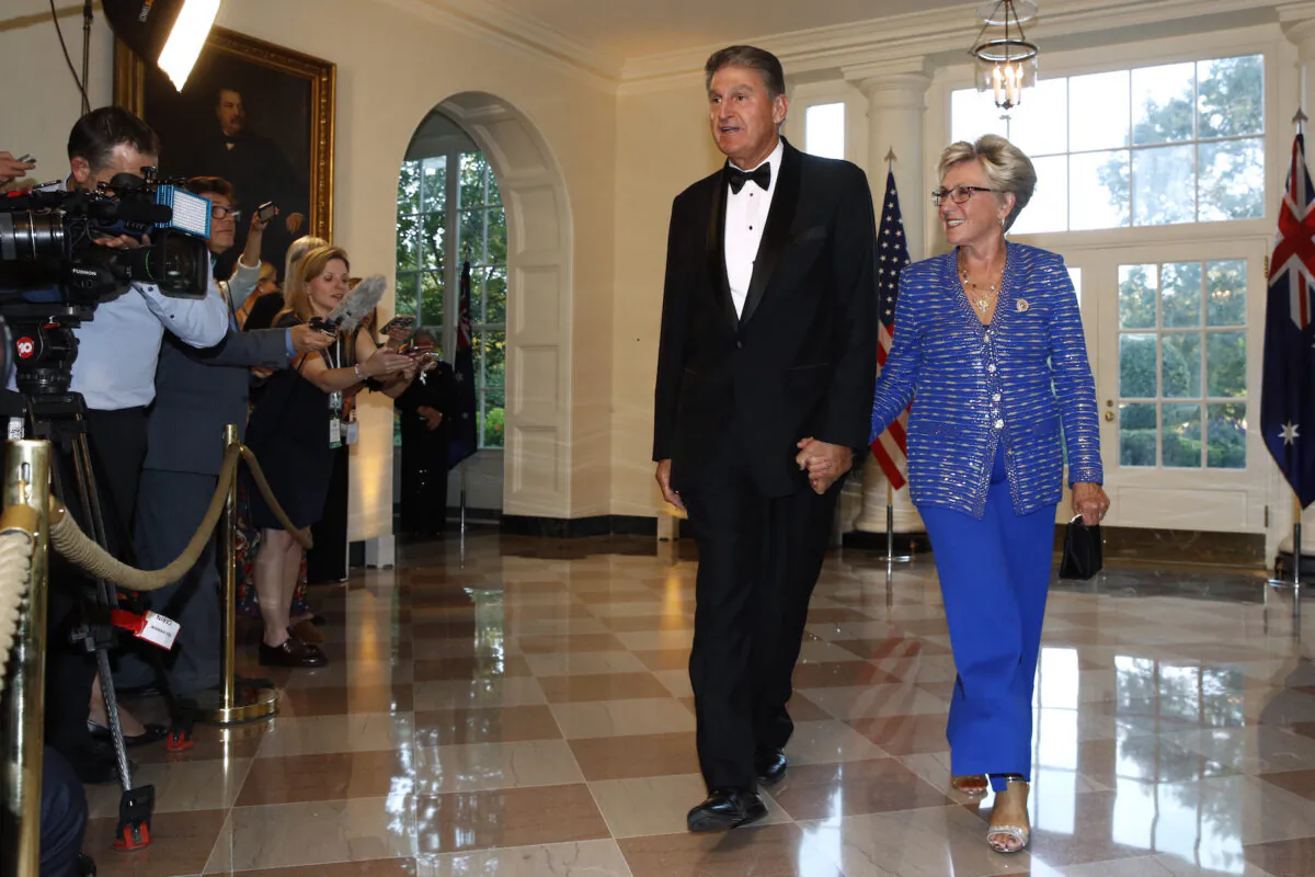 Sen. Joe Manchin, D-W.Va., left, and wife Gayle Conelly Manchin arrive for a State Dinner with Australian Prime Minister Scott Morrison and President Donald Trump at the White House, in Washington on Sept. 20, 2019. (Patrick Semansky/AP Photo)
