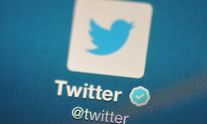 In this photo illustration, the Twitter logo is displayed on a mobile device in London, England on Nov. 7, 2013. (Bethany Clarke/Getty Images)