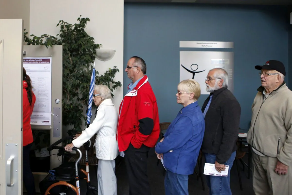 People wait in line to cast their ballots in Sidney, B.C., in Canada’s last federal election on Oct. 19, 2015. (The Canadian Press/Chad Hipolit)