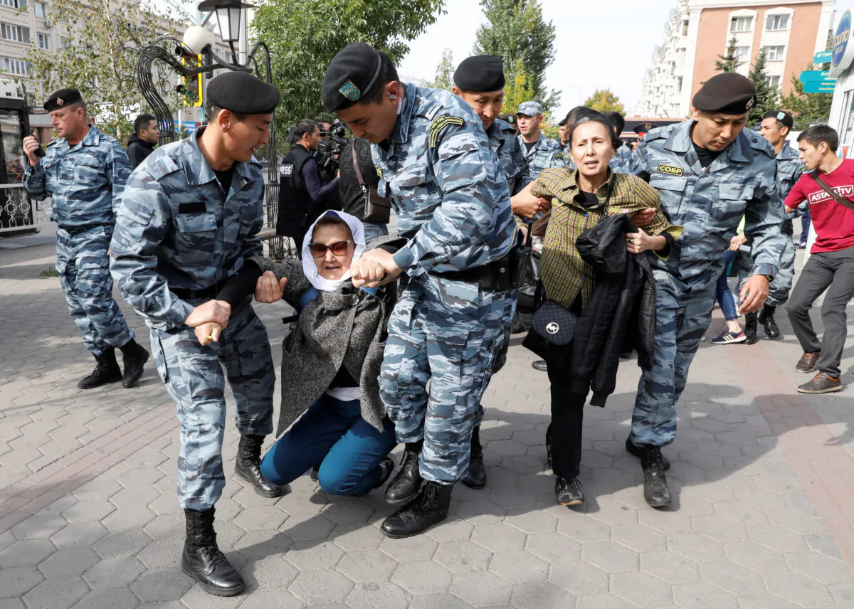 Kazakh law enforcement officers detain women during a rally held by opposition supporters in Nur-Sultan, Kazakhstan on Sept. 21, 2019. (Mukhtar Kholdorbekov/Reuters)