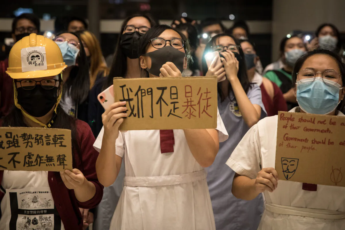 Secondary school students sing songs and chant slogans during a sing-along protest inside a shopping mall in Hong Kong on Sept. 23, 2019. (Chris McGrath/Getty Images)