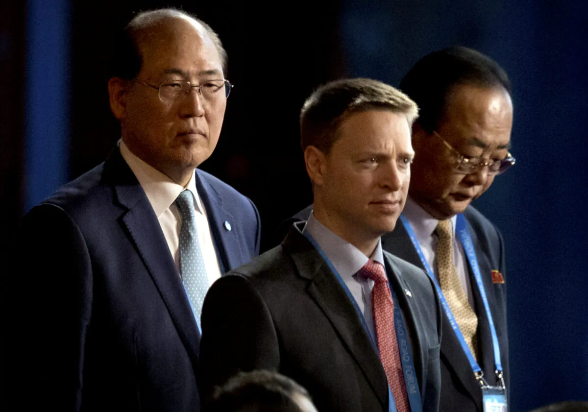 Matt Pottinger (C), Special Assistant to U.S. President Donald Trump and National Security Council (NSC) Senior Director for East Asia, and Kim Yong Jae (R), North Korea's minister of external economic relations, arrive for the opening ceremony of the Belt and Road Forum at the China National Convention Center (CNCC) in Beijing, on May 14, 2017. (AP Photo/Mark Schiefelbein)