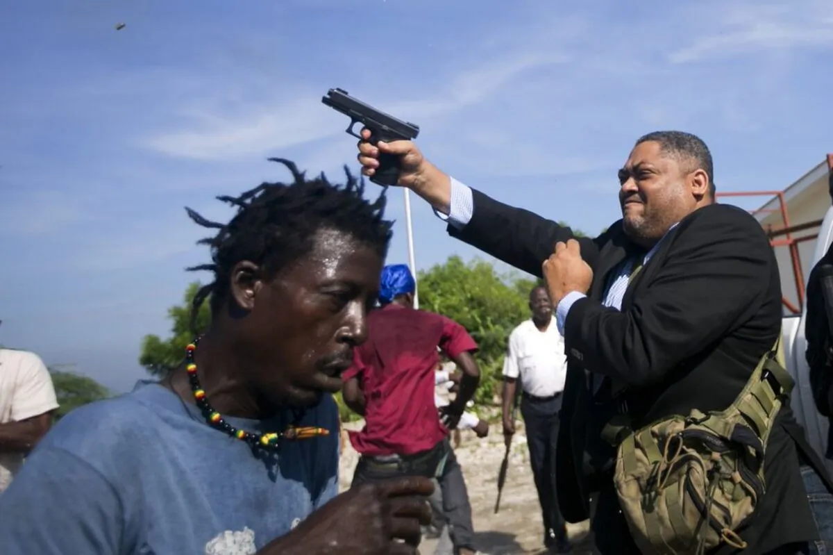 Ruling party Senator Ralph Fethiere fires his gun outside Parliament as he arrives for a vote on the ratification of Fritz William Michel's nomination as prime minister in Port-au-Prince, Haiti, on Sept. 23, 2019. (Dieu Nalio Chery/AP Photo)