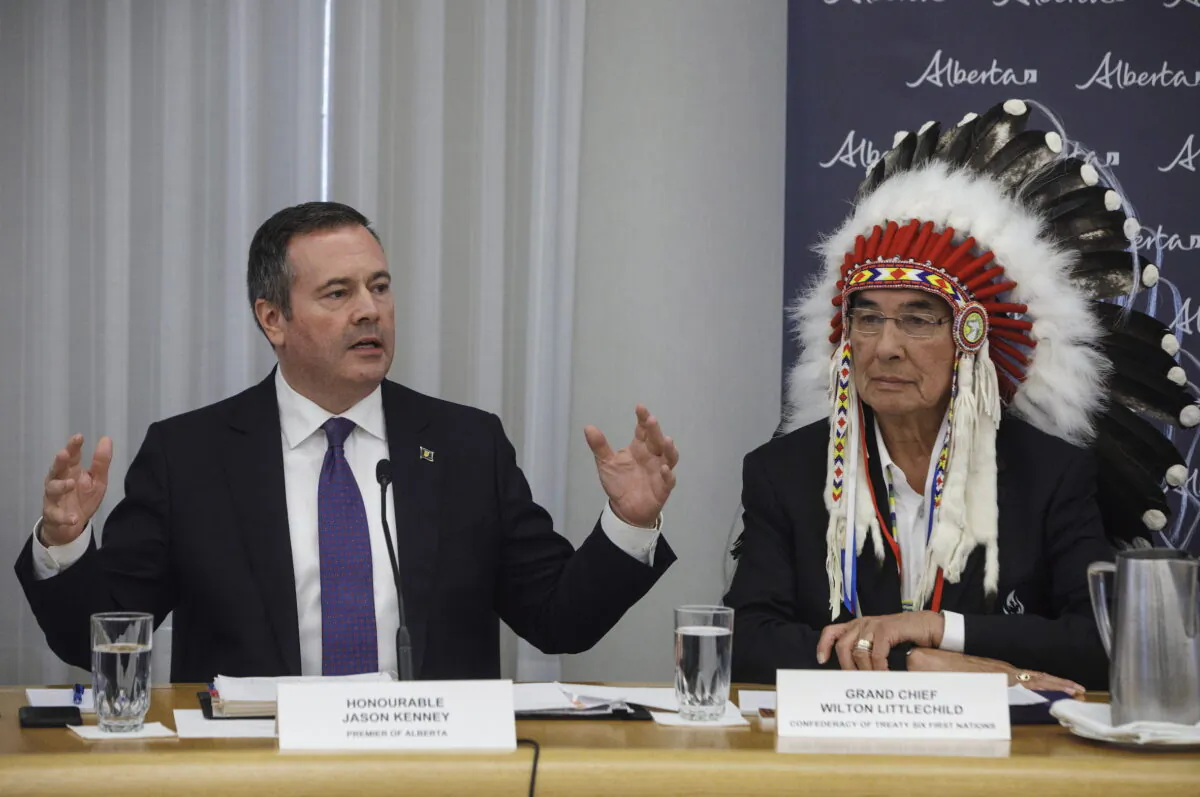 Alberta Premier Jason Kenney sits with Grand Chief Wilton Littlechild during a meeting with First Nations Chiefs and Grand Chiefs about increasing Indigenous participation in the economy, in Edmonton on June 10, 2019. (The Canadian Press/Jason Franson)