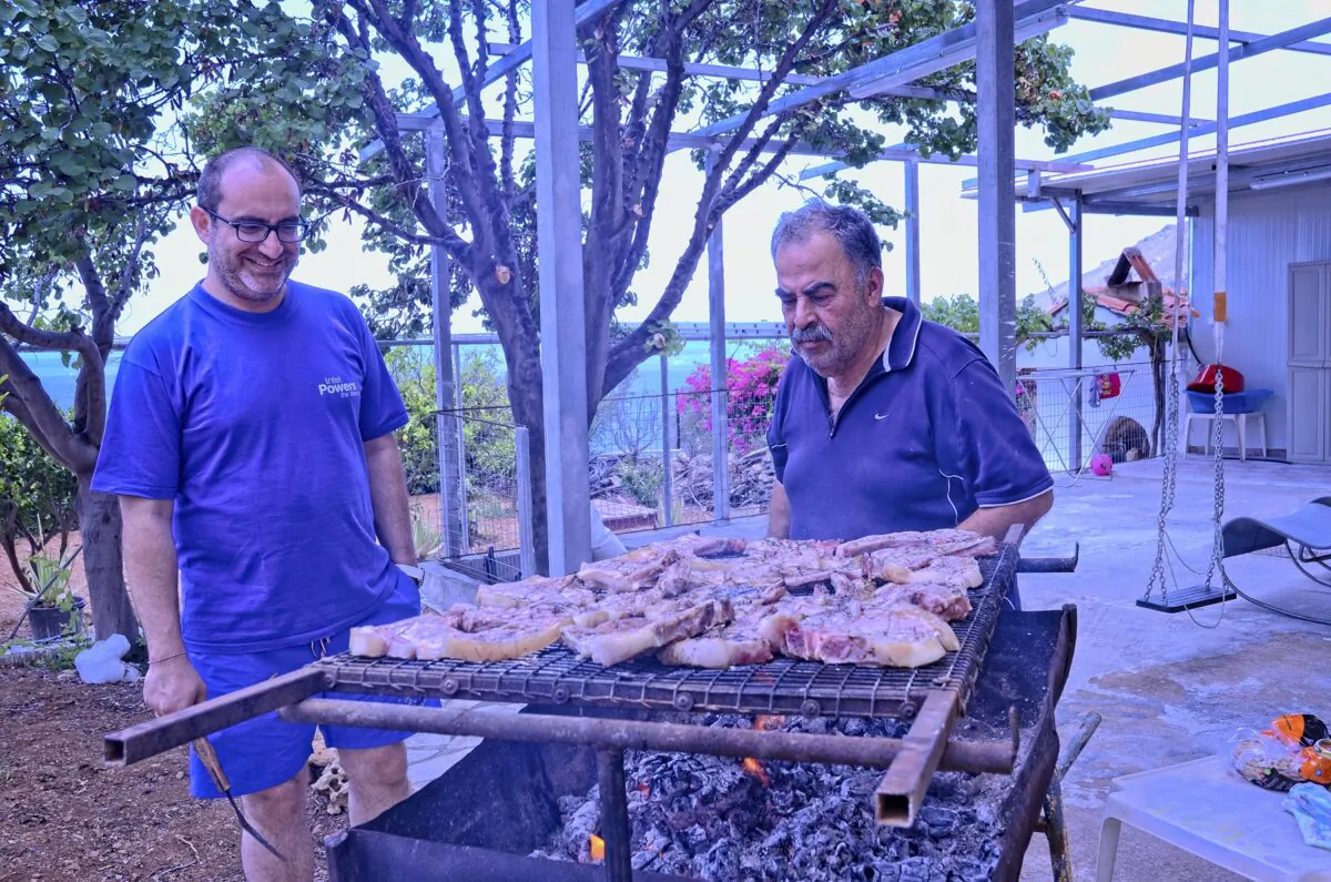 Minas Liapakis and his father-in-law Nikos Merkoulidis cooking out in Tsoutsouras. (Phil Butler)