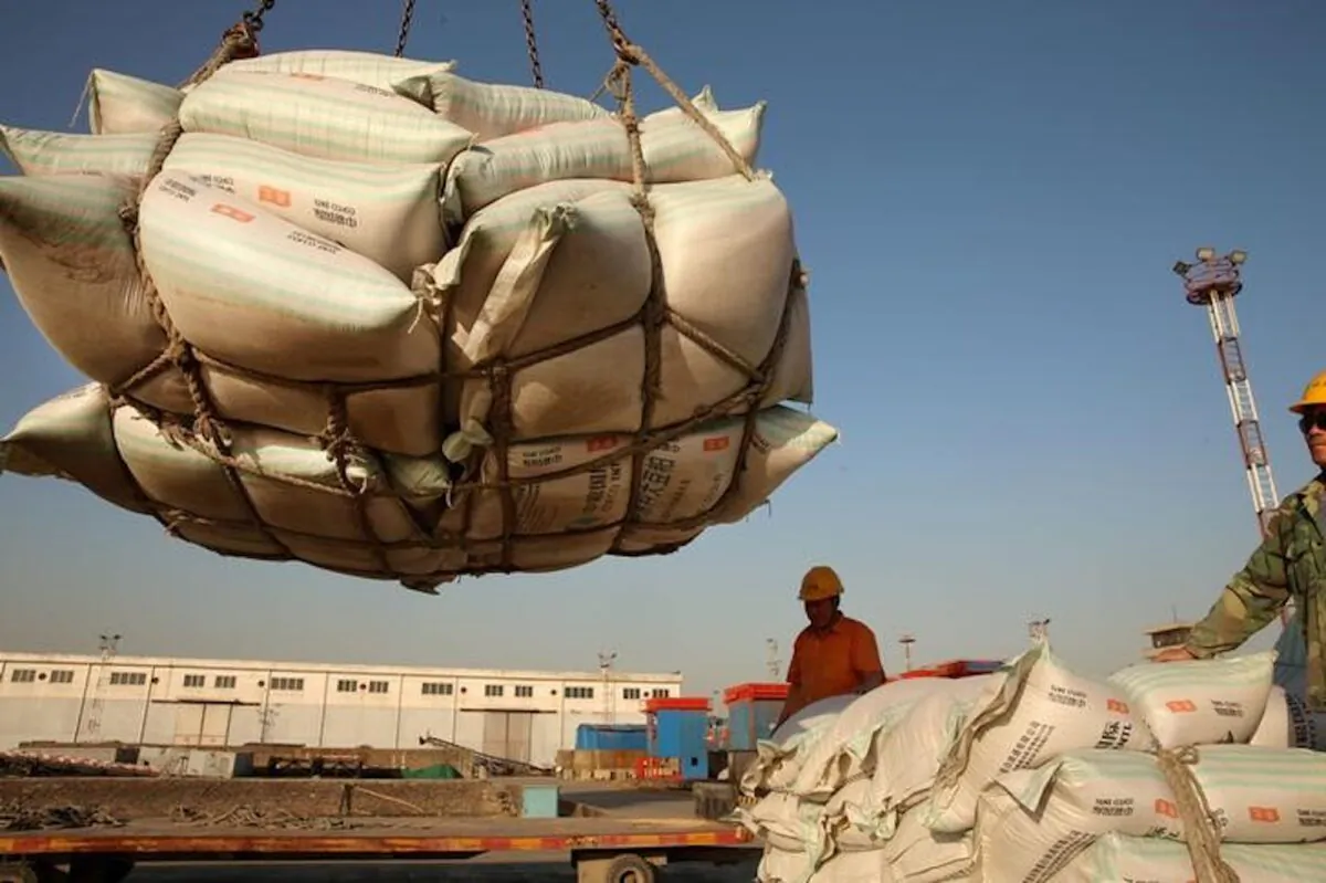 Workers transport imported soybean products at a port in Nantong, Jiangsu Province, China on April 9, 2018. (Reuters)