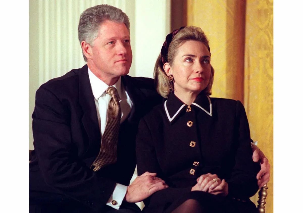 Then-President Bill Clinton (L) and First Lady Hillary Clinton listen to speakers at a Coalition for America's Children event at the White House in Washington on March 3, 1997. (JOYCE NALTCHAYAN/AFP/Getty Images)