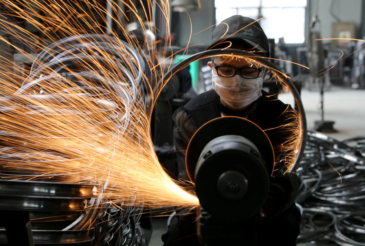 A worker welds a bicycle steel rim at a factory manufacturing sports equipment in Hangzhou, Zhejiang Province, China on Sept. 2, 2019. (China Daily via Reuters)