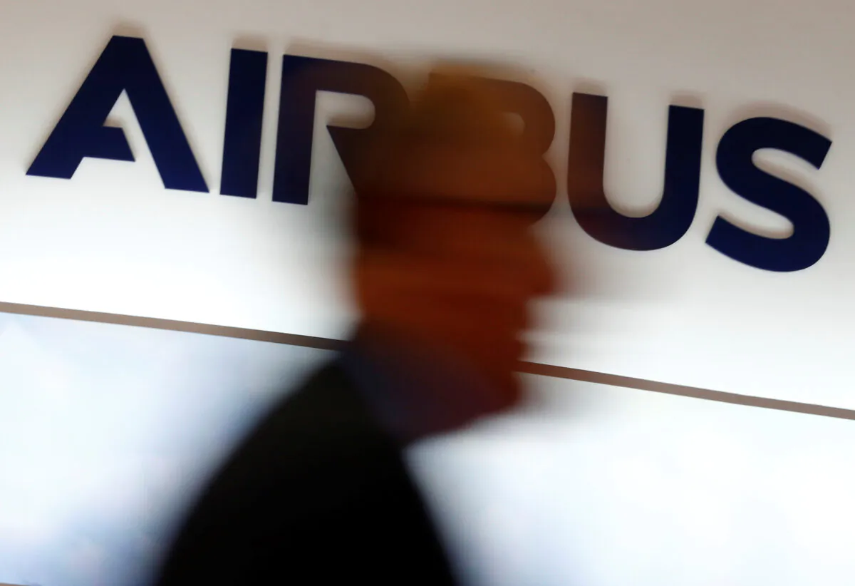 A man walks past an Airbus logo at the Langkawi International Maritime and Aerospace Exhibition in Langkawi, Malaysia on March 28, 2019. (Feline Lim/Reuters)