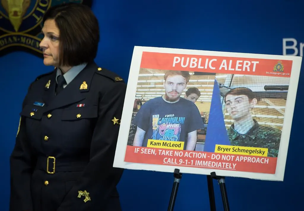 Security camera images recorded in Saskatchewan of Kam McLeod, 19, and Bryer Schmegelsky, 18, are displayed as RCMP Sgt. Janelle Shoihet listens during a news conference in Surrey, B.C., on July 23, 2019. (The Canadian Press/Darryl Dyck)