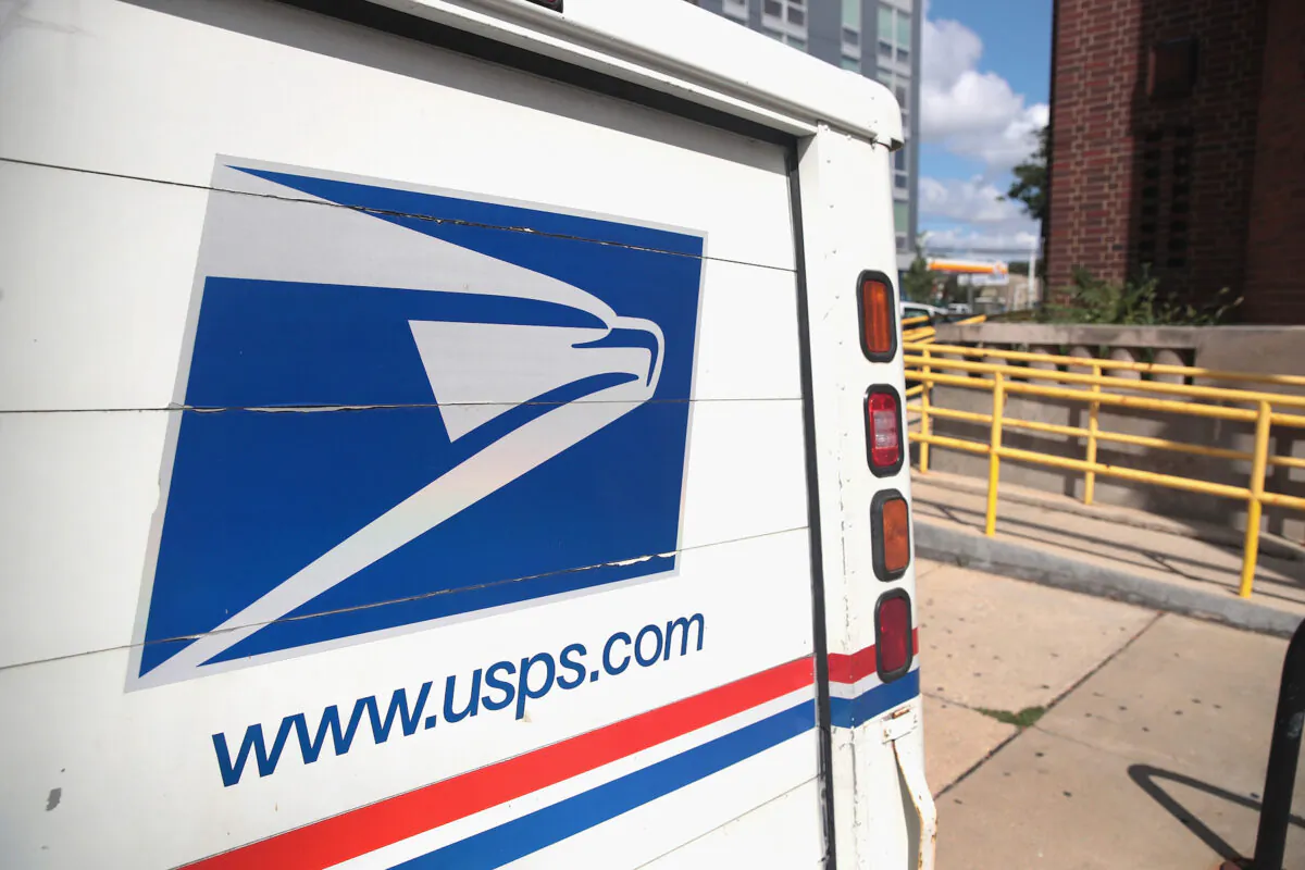 A United States Postal Service (USPS) truck leaves a postal facility in a file photograph. (Scott Olson/Getty Images)