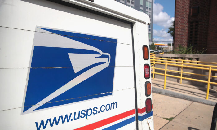 A United States Postal Service (USPS) truck leaves a postal facility in a file photograph. (Scott Olson/Getty Images)