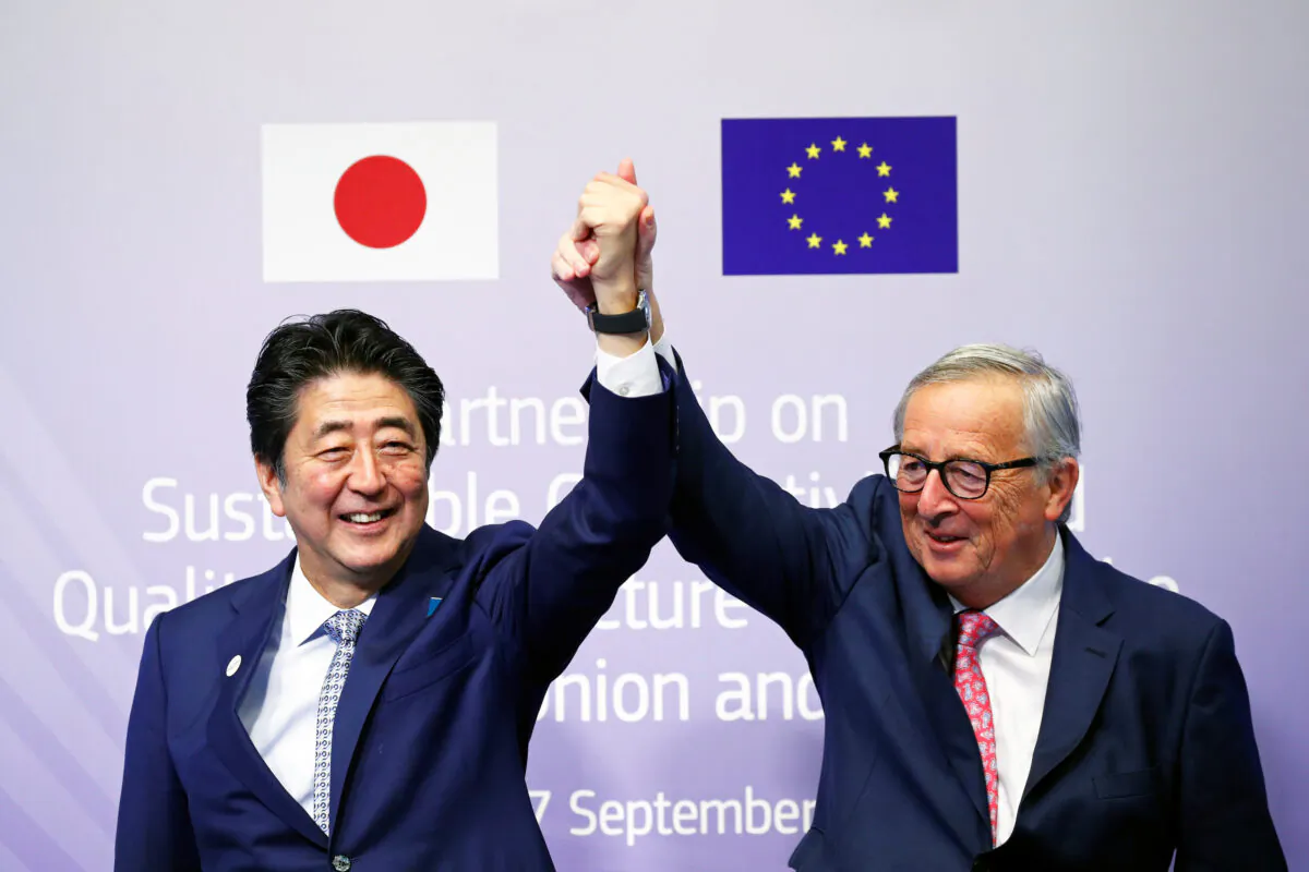 European Commission President Jean-Claude Juncker and Japan's Prime Minister Shinzo Abe gesture during the conference Communication Connecting Europe and Asia, in Brussels, Belgium on Sept. 27, 2019. (Francois Lenoir/Reuters)