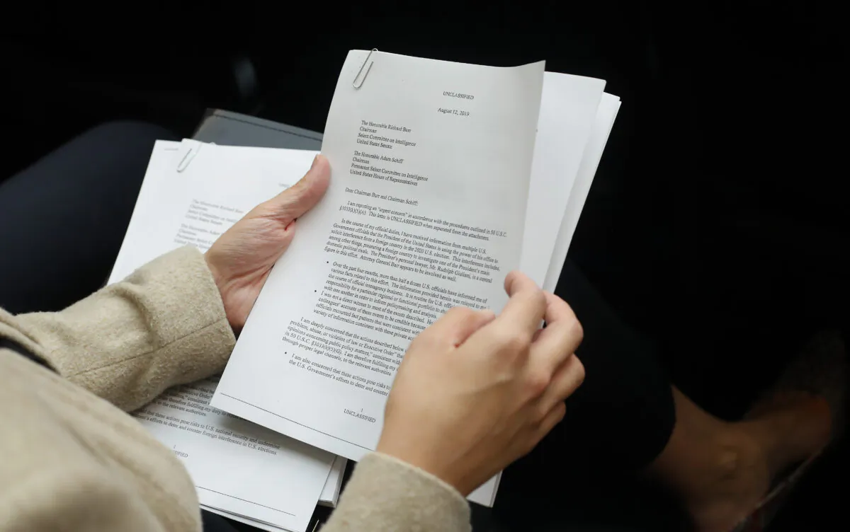 A member of the audience holds a copy of the Whistle-Blower Complaint letter sent to Senate and House Intelligence Committees during testimony by Acting Director of National Intelligence Joseph Maguire before the House Intelligence Committee on Capitol Hill in Washington on Sept. 26, 2019. (Pablo Martinez Monsivais/AP Photo)