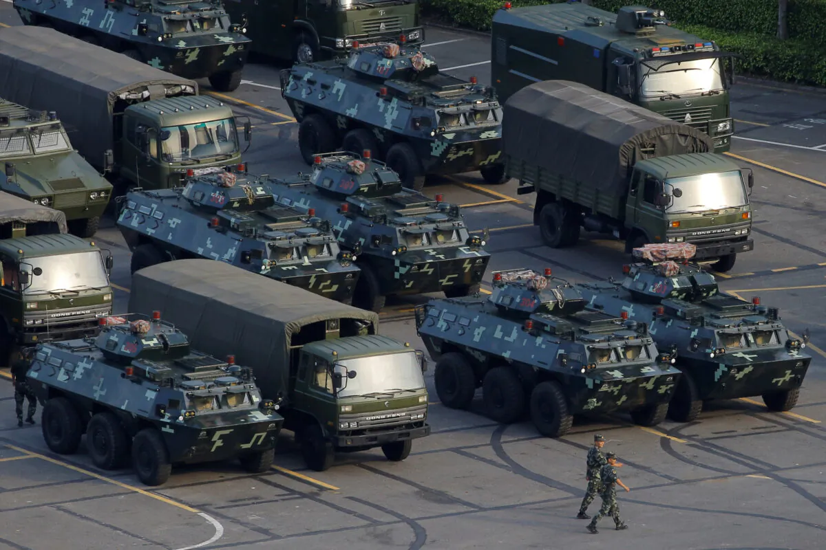 Military vehicles are parked on the grounds of the Shenzhen Bay Sports Center in Shenzhen, China on Aug. 15, 2019. (Thomas Peter/Reuters)