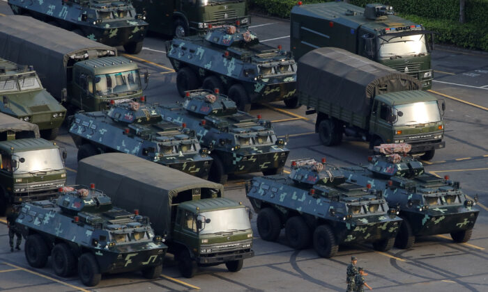 Military vehicles are parked on the grounds of the Shenzhen Bay Sports Center in Shenzhen, China on Aug. 15, 2019. (Thomas Peter/Reuters)