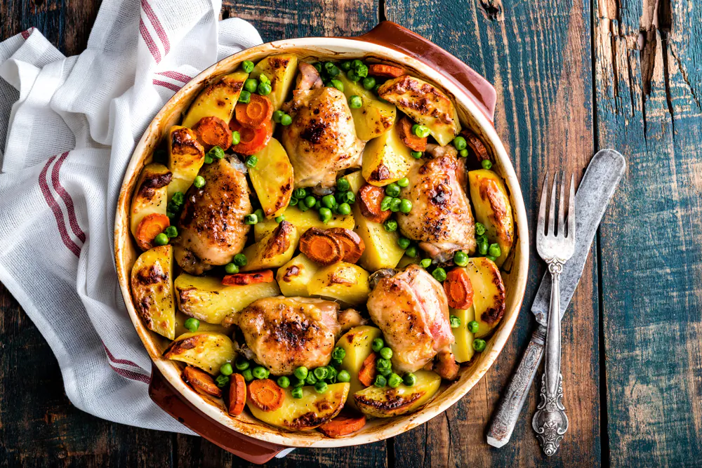 Chicken and vegetables, rice and beans, a pan of sliced fruit—all transform in the heat of the oven, with little hands-on effort required. (Shutterstock)