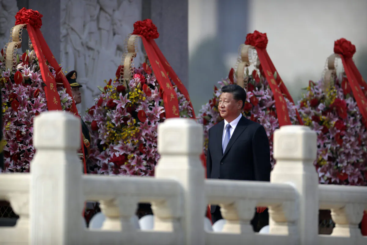 Chinese leader Xi Jinping walks past floral wreaths at the Monument to the People's Heroes during a ceremony at Tiananmen Square in Beijing on Sept. 30, 2019. (Mark Schiefelbein - Pool/Getty Images)