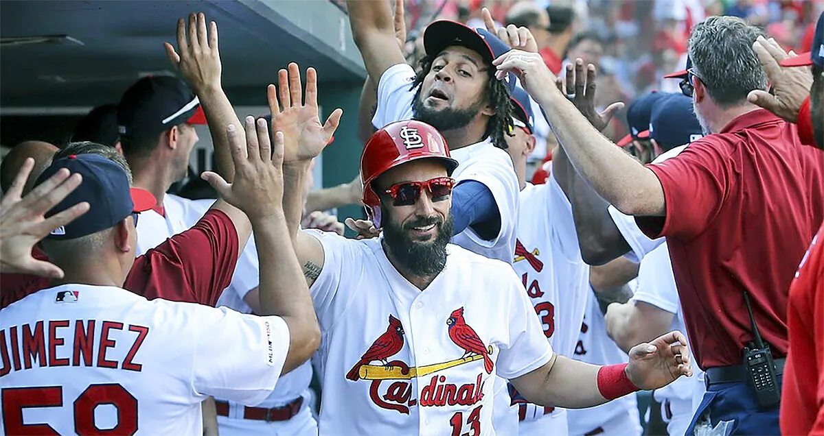 St. Louis Cardinals Infielder Matt Carpenter (C) gives high fives after hitting a three-run home run at Busch Stadium in St. Louis, Mo., on Sept. 29, 2019. (Scott Kane/AP Photo)