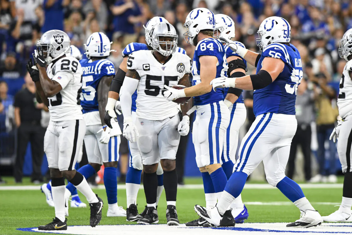 Oakland Raiders outside linebacker Vontaze Burfict (55) speaks with Indianapolis Colts tight end Jack Doyle (84) after his helmet-to-helmet hit on Doyle during the first half of an NFL football game in Indianapolis on Sept. 29, 2019. Burfict has been suspended for the rest of the season for the hit. (AP Photo/Doug McSchooler)