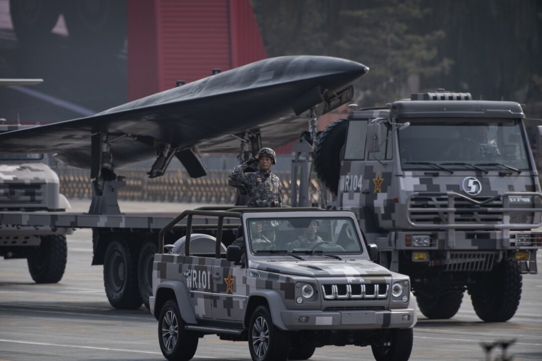 A Chinese soldier salutes in front of a military drone during a parade to celebrate the 70th anniversary of the founding of the Chinese communist regime at Tiananmen Square in Beijing on Oct. 1, 2019. (Kevin Frayer/Getty Images)