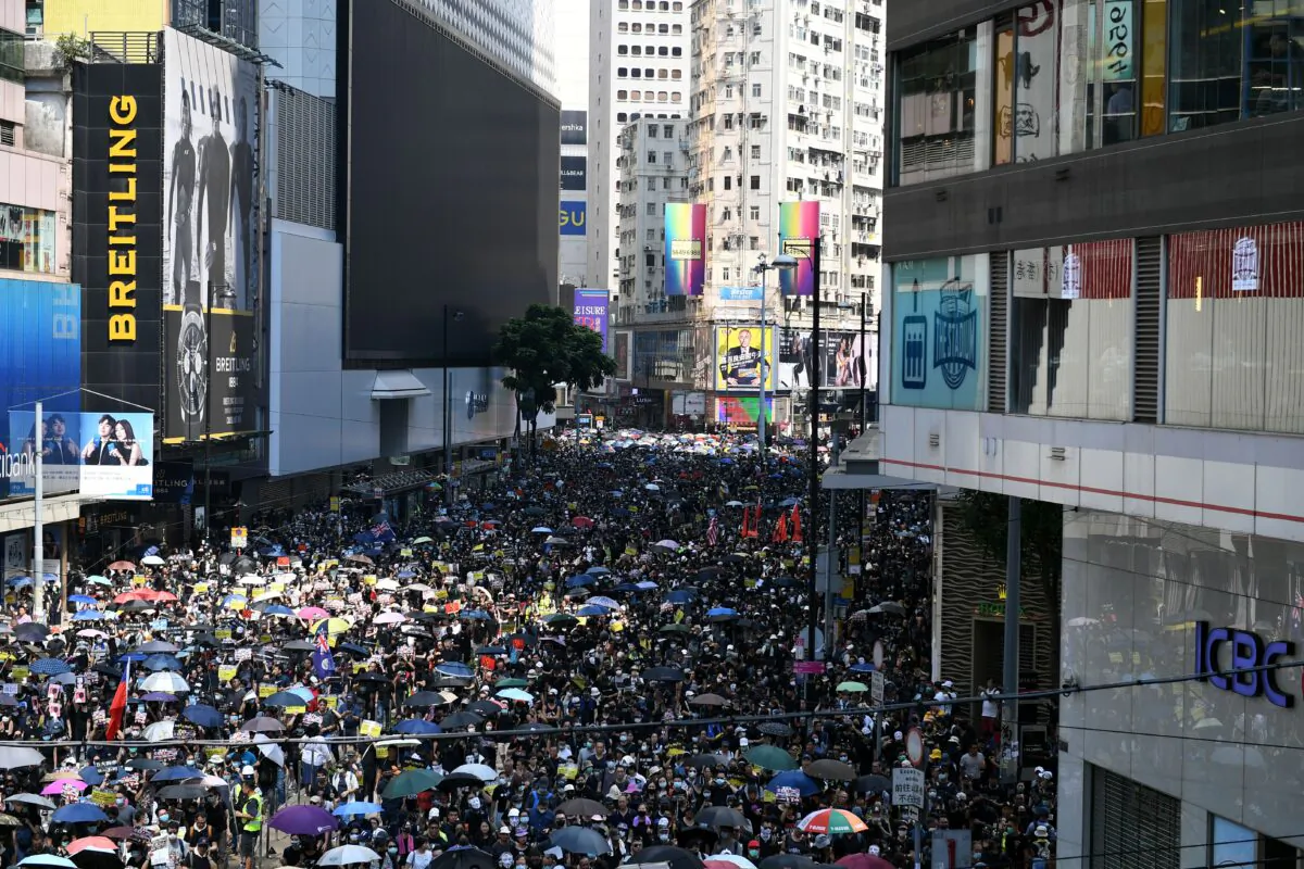 People take part in a march in the Causeway Bay shopping district in Hong Kong on Oct. 1, 2019. (Mohd Rasfan/AFP/Getty Images)
