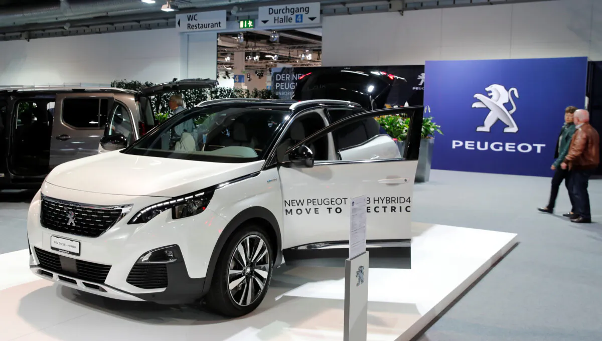 The logo of French car manufacturer Peugeot is seen behind a SUV 3008 Hybrid4 car displayed at the 33th Auto Zuerich Car Show in Zurich, Switzerland Oct. 31, 2019. (Arnd Wiegmann/Reuters)