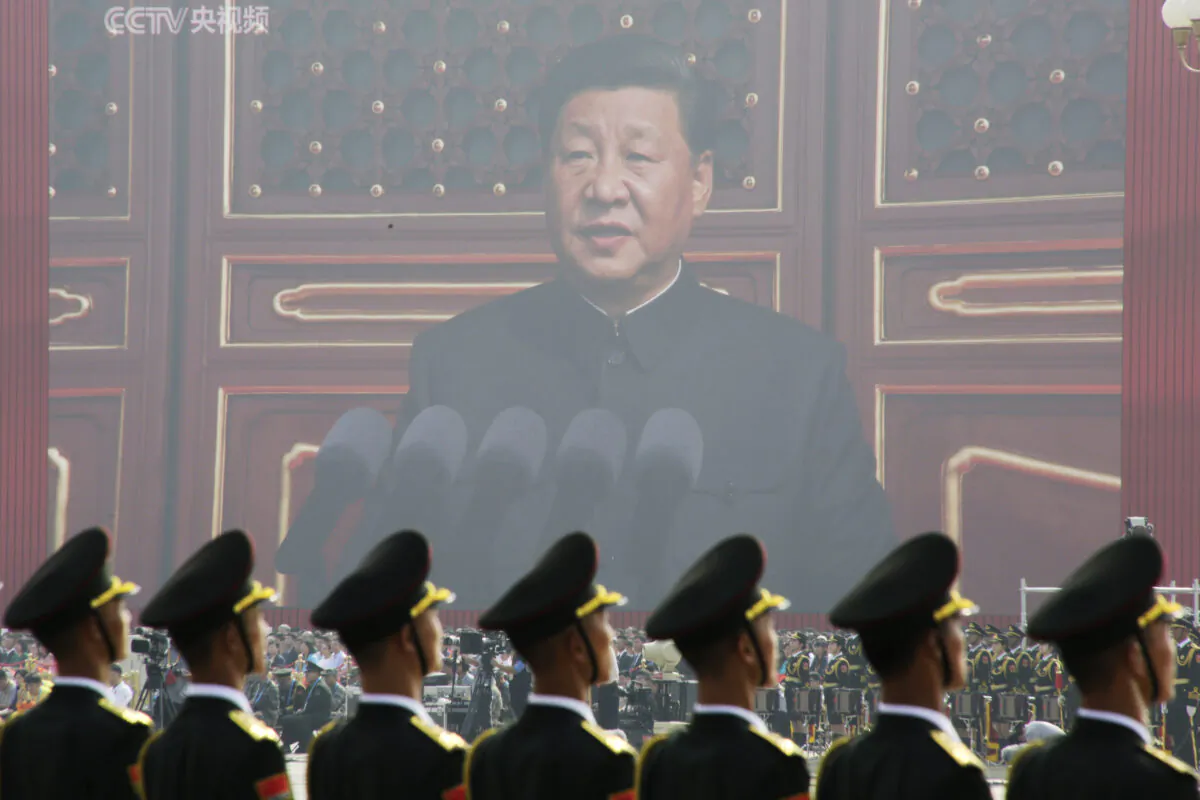 Soldiers of the People's Liberation Army are seen before a giant screen as Chinese leader Xi Jinping speaks at the military parade marking the 70th founding anniversary of the People's Republic of China, on its National Day in Beijing on Oct. 1, 2019. (Jason Lee/Reuters)