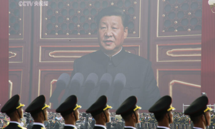 Soldiers of People's Liberation Army (PLA) are seen before a giant screen as Chinese leader Xi Jinping speaks at the military parade marking the 70th founding anniversary of the Chinese Communist Party, on its National Day in Beijing, China, on Oct. 1, 2019. (Jason Lee/Reuters)