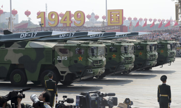 Military vehicles, carrying DF-17, roll down as members of a Chinese military honor guard march during the parade to commemorate the 70th anniversary of the founding of Communist China in Beijing on Oct. 1, 2019.  China's military has shown off a new hypersonic ballistic nuclear missile believed capable of breaching all existing anti-missile shields deployed by the U.S. and its allies. (Ng Han Guan/AP Photo)