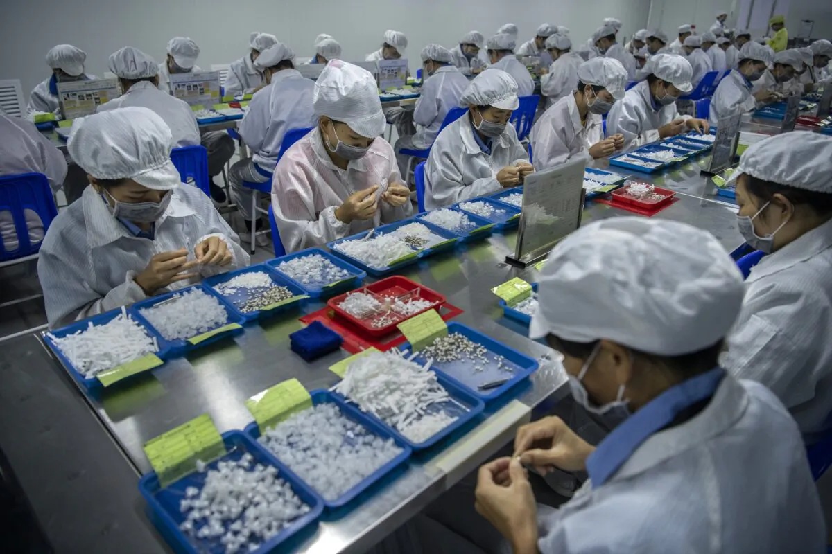 Workers assemble parts for e-cigarettes on the production line at KangerTech, one of China's leading manufacturers of vaping products in Shenzhen, China, on Sept. 24, 2019. (Kevin Frayer/Getty Images)
