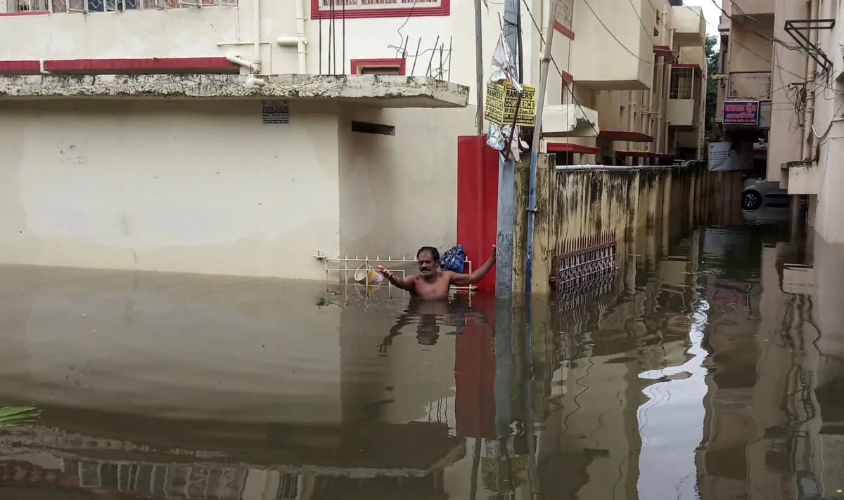 A man asks for help as he stands in the flood waters at a neighbourhood in Patna, in the eastern state of Bihar, India, Sept. 30, 2019. (Stringer/Reuters)