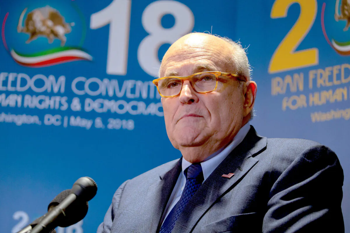 Rudy Giuliani takes questions from the media after speaking at the Conference on Iran in Washington on May 5, 2018. (Tasos Katopodis/Getty Images)