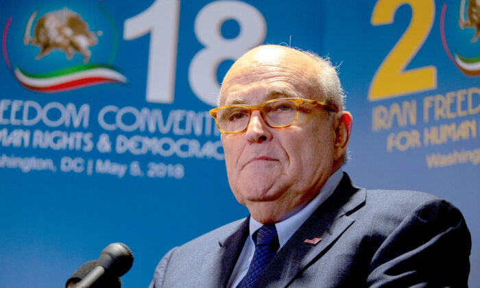 Rudy Giuliani takes questions from the media after speaking at the Conference on Iran in Washington on May 5, 2018. (Tasos Katopodis/Getty Images)