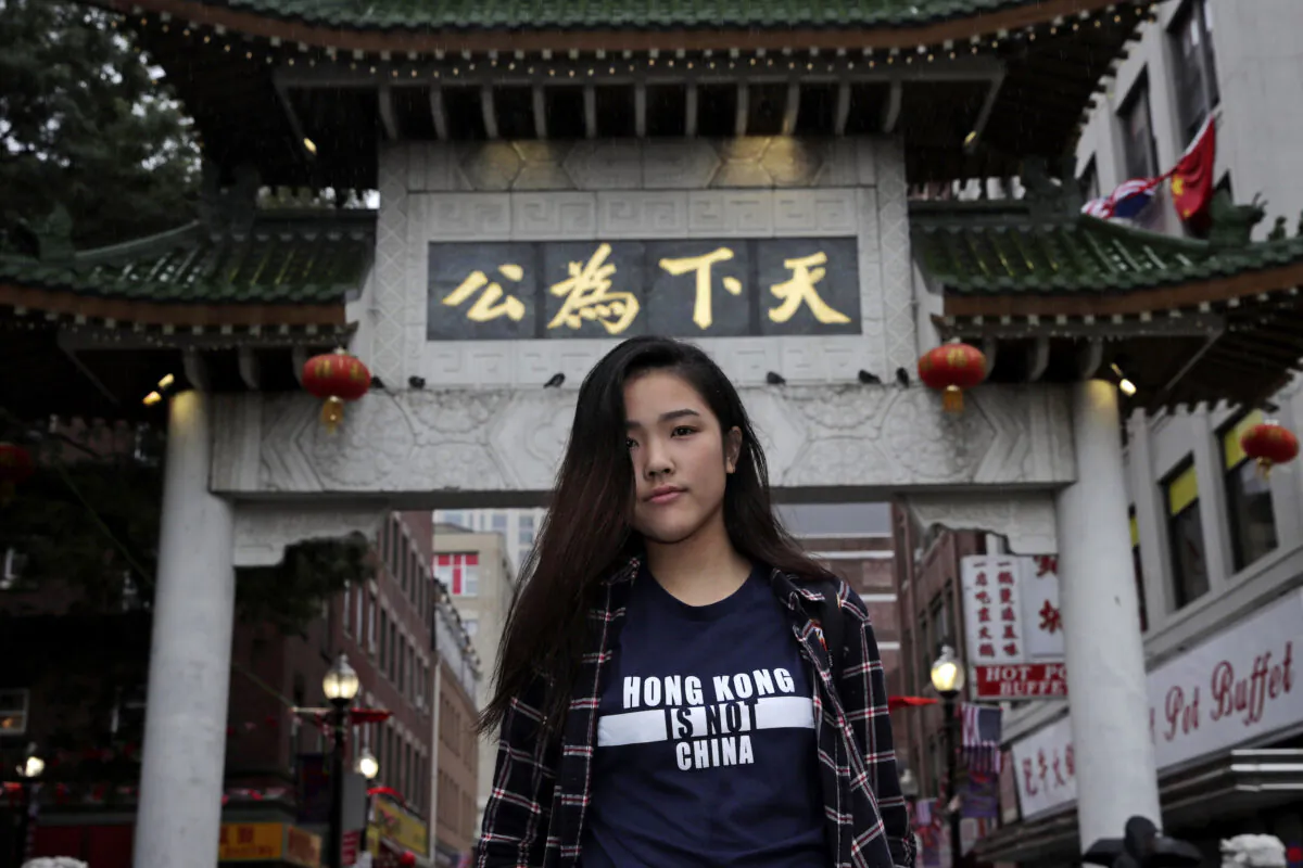 Emerson College student Frances Hui poses in the Chinatown neighborhood of Boston, U.S. on Oct. 2, 2019. Tensions over Hong Kong have been flaring at campuses around the world that host large numbers of visiting Chinese students. Hui, of Hong Kong, faced threatening language from classmates from mainland China after she published a column in the student newspaper, “I am from Hong Kong, not China.” (Charles Krupa/AP)