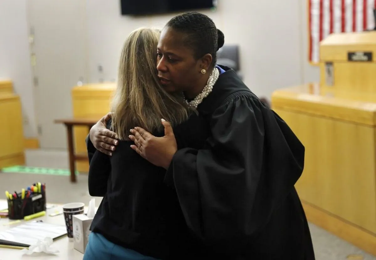 State District Judge Tammy Kemp gives former Dallas Police Officer Amber Guyger a hug before Guyger leaves for jail in Dallas on Oct. 2, 2019. (Tom Fox/The Dallas Morning News via AP, Pool)