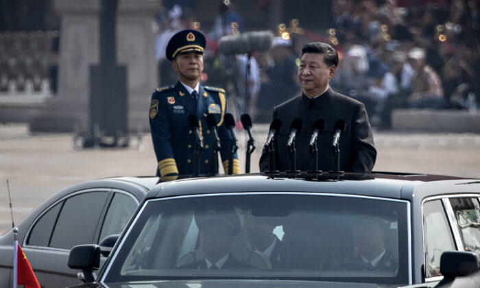 Chinese President Xi Jinping drives in a car after inspecting the troops during a parade to celebrate the 70th anniversary of the founding of the People's Republic of China in 1949, at Tiananmen Square in Beijing on Oct. 1, 2019. (Kevin Frayer/Getty Images)