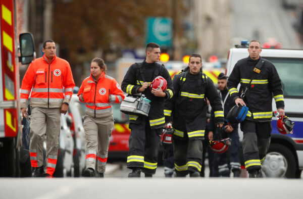 French police and firefighters are seen in front of the Paris Police headquarters in Paris