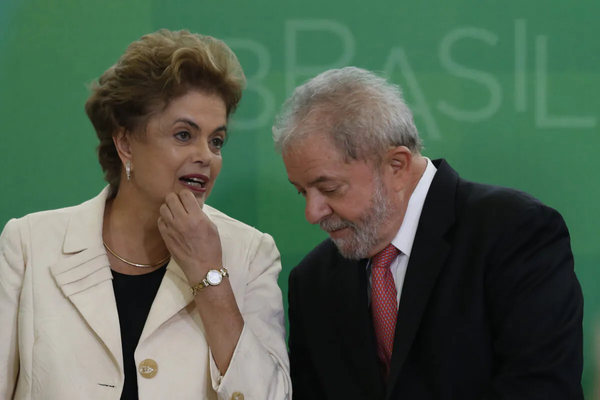 Brazil's former president, Luiz Inacio Lula da Silva talks with then-Brazil President Dilma Rousseff as he is sworn in as the new chief of staff in the Planalto Palace on March 17, 2016, in Brasilia, Brazil. (Igo Estrela/Getty Images)