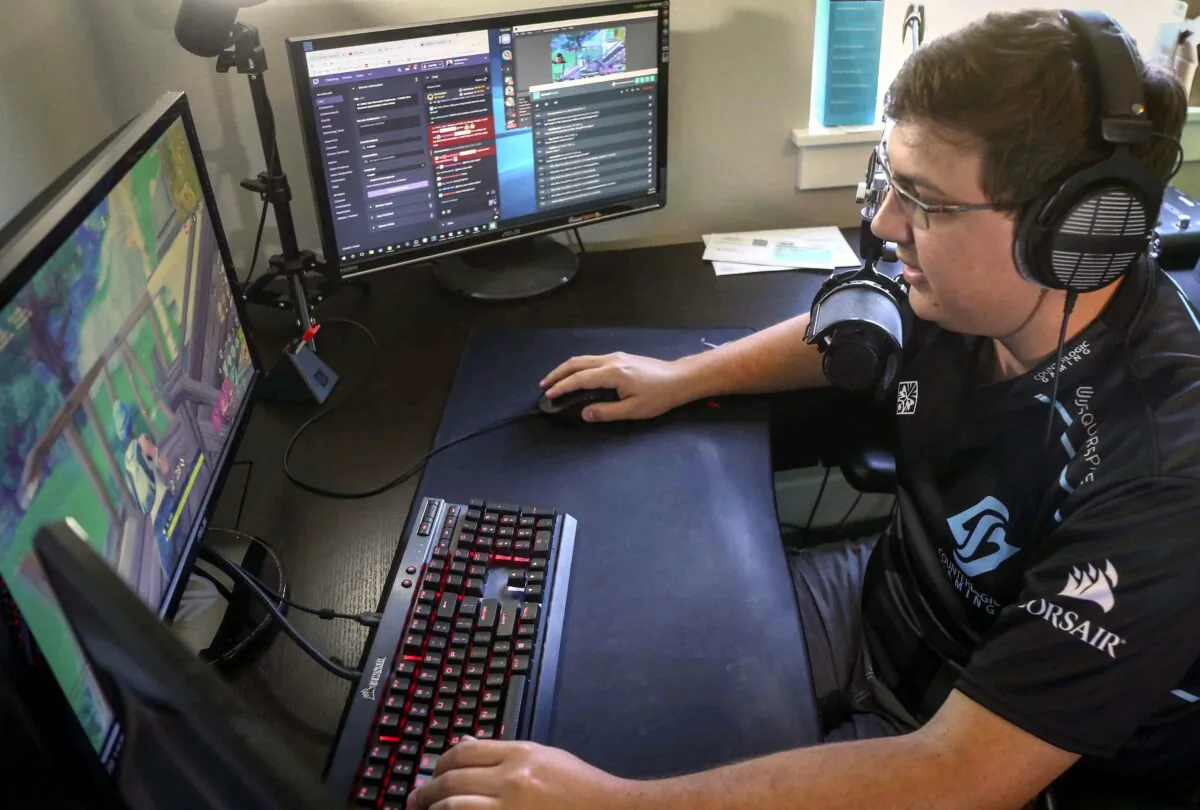 Nick Overton, a professional video game player, plays Fortnite while engaging with his fans online from his home in Grimes, Iowa on Sept. 11, 2018. A Quebec law firm is seeking to launch a class-action lawsuit against the makers of Fortnite, alleging it is highly addictive and can cause health problems. (The Canadian Press/Bryon Houlgrave/The Des Moines Register/AP)