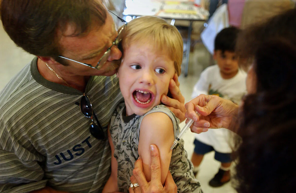 An incoming kindergartener reacts to a Measles, Mumps and Rubella vaccination (MMR) in Santa Ana, Calif., on Aug. 26, 2002. (David McNew/Getty Images)