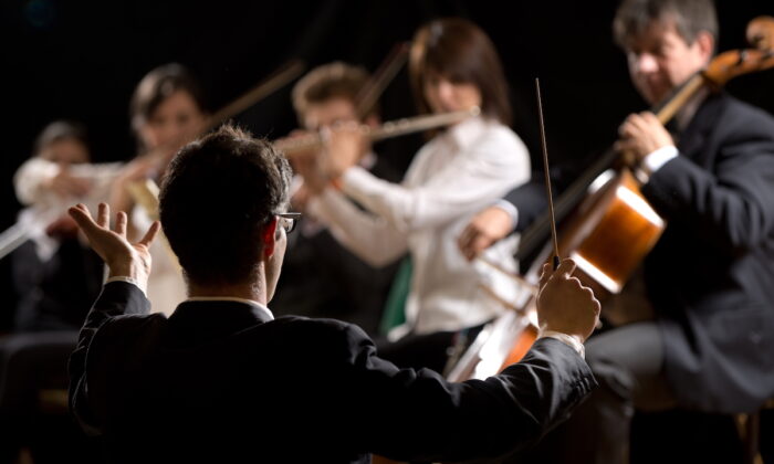 The conductor’s role is to communicate with the performers and their audience. Their role is part artistic, part mathematical. (Shutterstock)